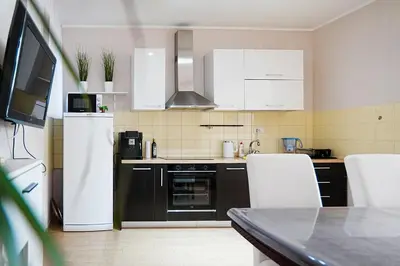 a kitchen with white appliances and white cabinets at Lemon Villa in Bar