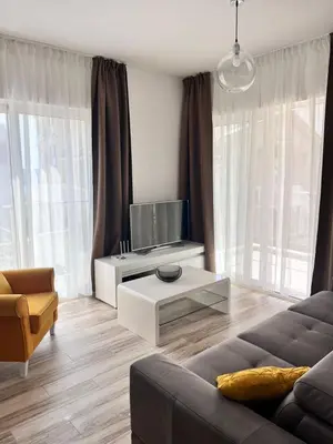 a living room with a couch and a tv at Your Sunny vacation in Budva