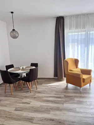 a living room with a table and chairs and a chair and a table and chair at Your Sunny vacation in Budva