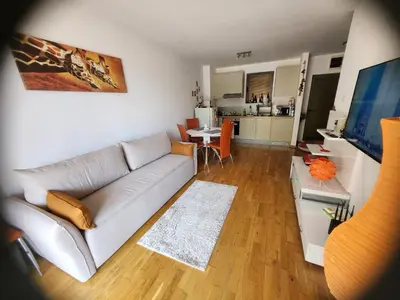 a living room with a couch and a table at 1-Bedroom Appartament mit Pool in Pržno