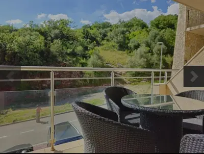 a balcony with a table and chairs and a view at 1-Bedroom Appartament mit Pool in Pržno