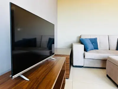 a large flat screen tv in a living room with a couch at MonteСharm in Sutomore