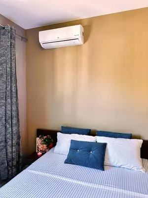 a bedroom with a bed with a air conditioner on the wall at MonteСharm in Sutomore