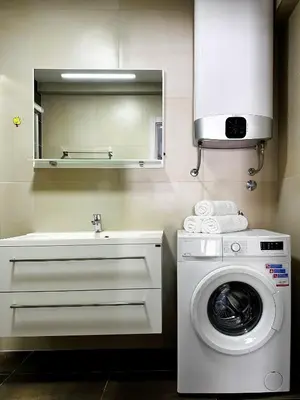 a bathroom with a washing machine and a sink at MonteСharm in Sutomore