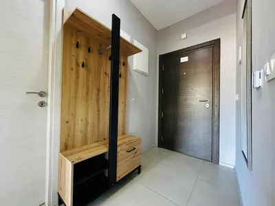 a hallway with a wooden door in a house at MonteСharm in Sutomore