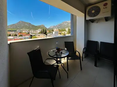 a small table and chairs in a room with a window at MonteСharm in Sutomore