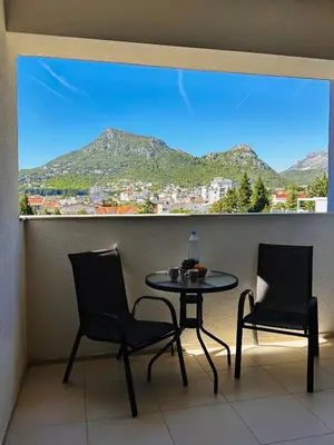 a table and two chairs in a balcony with a view at MonteСharm in Sutomore