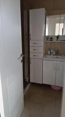 a kitchen with white cabinets and a sink at SeaCharm in Dobra Voda