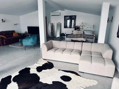 a living room with a white couch and a rug at Villa Luna Blue in Brca
