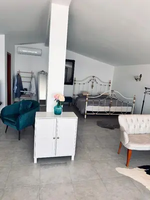 a living room with a white cabinet and a bed at Villa Luna Blue in Brca