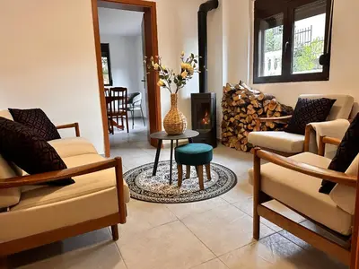 a living room with a table and a vase with flowers at Villa Luna Blue in Brca