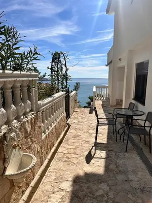 a patio with a table and chairs and the ocean at Villa Luna Blue in Brca