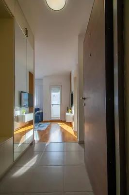 a hallway with a door leading to a bathroom at NYC Apartman with garage in Podgorica