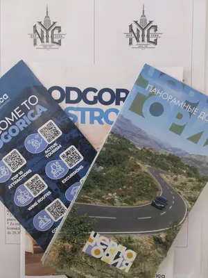 a poster of a road and a magazine at NYC Apartman with garage in Podgorica