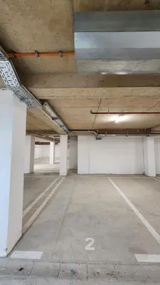 an empty parking lot in a parking garage at NYC Apartman with garage in Podgorica
