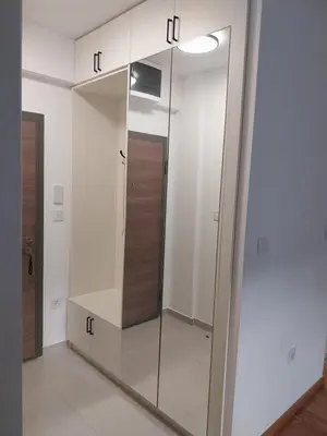 a walk in closet with a glass door at NYC Apartman with garage in Podgorica