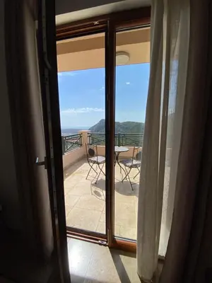 a door to a balcony with a view of the ocean at Villa Nika in Brežani