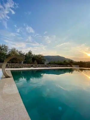 a large swimming pool with blue water at Villa Nika in Brežani