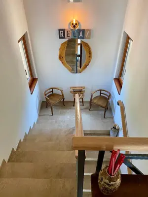 a room with stairs with chairs and a mirror at Villa Nika in Brežani