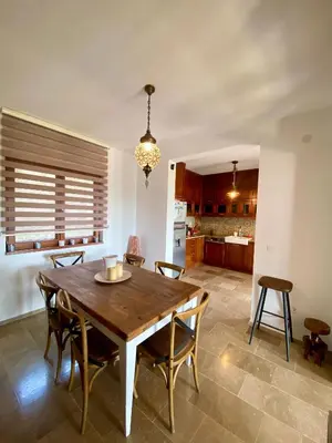 a kitchen and dining room with a wooden table and chairs at Villa Nika in Brežani