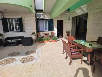 a patio with a table and chairs and a couch at Montesan Luxury Apartments Sveti Stefan in Sveti Stefan