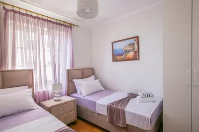 a bedroom with two beds and a window at Montesan Luxury Apartments Sveti Stefan in Sveti Stefan