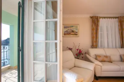 a living room with a glass door leading into a living room at Montesan Luxury Apartments Sveti Stefan in Sveti Stefan