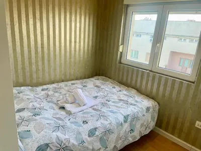 a bed with two stuffed animals on it in a bedroom at City center 34 in Podgorica