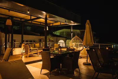 a patio with a table and chairs and an umbrella at Villa Oleander in Ulcinj
