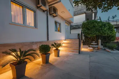 a courtyard with potted plants in front of a building at Villa Oleander in Ulcinj