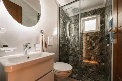a bathroom with a toilet and a sink and a shower at Villa Oleander in Ulcinj