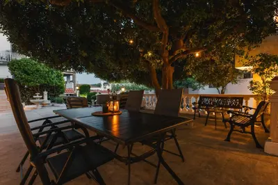 a table and chairs on a patio under a tree at Villa Oleander in Ulcinj