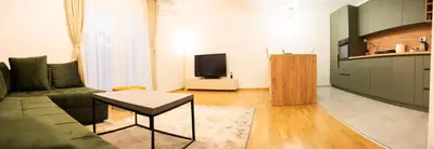 a living room with a couch and a tv at Apartament ZHana in Podgorica