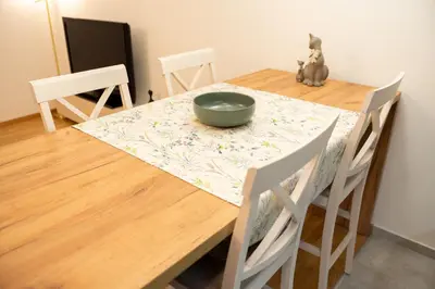 a wooden table with a bowl on top of it at Apartament ZHana in Podgorica