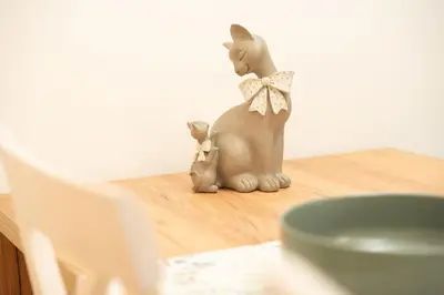 a figurine of a cat and a kitten on a table at Apartament ZHana in Podgorica