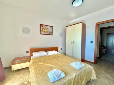 a bedroom with a bed with two pillows on it at Sea view Apartments Rafailovici in Budva