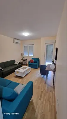 a living room with a blue couch and a table at Apartment Katarina in Podgorica