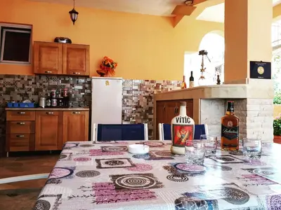 a kitchen with a table with a bottle of wine at Apartments Vitic in Sutomore