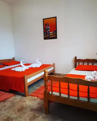 two beds sitting next to each other in a room at Apartments Vitic in Sutomore