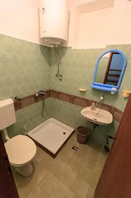 a bathroom with a toilet and a sink at Apartments Vitic in Sutomore