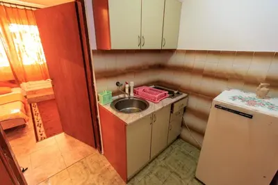 a small kitchen with a sink and a refrigerator at Apartments Vitic in Sutomore