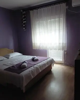 a bedroom with a bed with two towels on it at Apartments Vitic in Sutomore