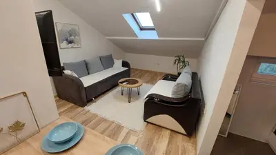 a living room with a couch and a table at DMD Apartman in Podgorica