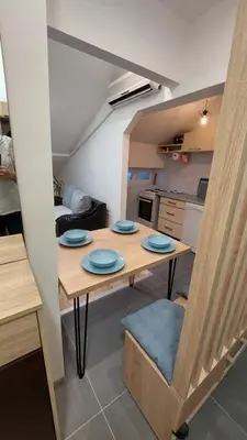 a kitchen with a table with blue plates on it at DMD Apartman in Podgorica