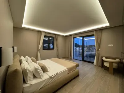 a bedroom with a large bed and a large window at Exclusive villa Kaza - Przno in Budva