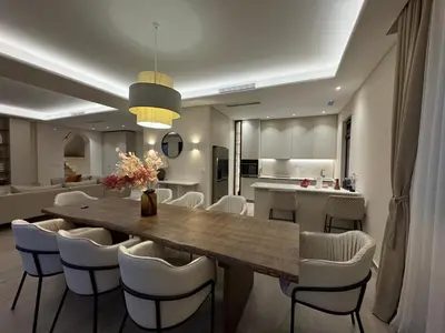 a kitchen and dining room with a table and chairs at Exclusive villa Kaza - Przno in Budva