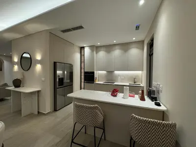 a kitchen with a counter and some chairs in a room at Exclusive villa Kaza - Przno in Budva