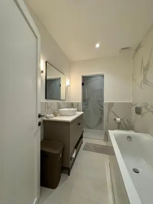 a white bathroom with a tub and a sink and a bath tub at Exclusive villa Kaza - Przno in Budva