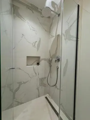 a bathroom with a shower with a glass door at Exclusive villa Kaza - Przno in Budva