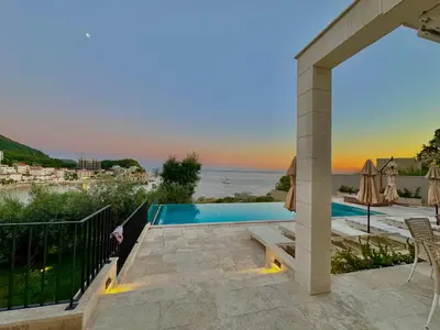 a villa with a swimming pool and a view of the ocean at Exclusive villa Kaza - Przno in Budva
